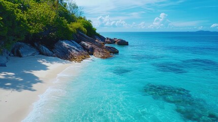 Fototapeta premium Serene tropical beach with crystal clear waters and rocks
