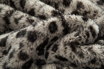 Soft faux fur fabric with leopard print pattern, perfect for cozy decor