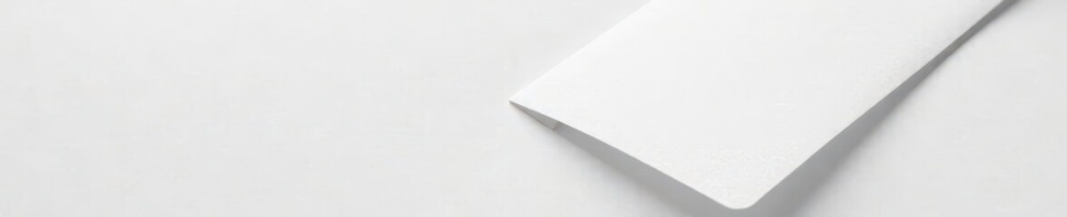 Plain white surface with a simple white envelope, simple, white