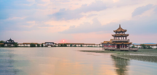 Fototapeta premium An ancient building complex and sunset scenery on the Taihu Lake Lake in Wuxi, Jiangsu Province, China will be on June 3, 2024