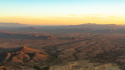 Sonoran Desert mountains and dirt fields in Phoenix Arizona on an autumn October day. Photo taken during sunrise	
