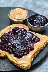 Peanut butter and blueberry jelly on toast close up.