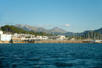 Naklejka premium A picturesque scene of boats lined up at Port d'Andratx, Mallorca, with stunning mountains in the background