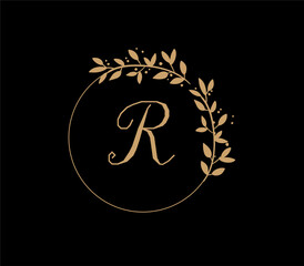 The logo has an elegant and classic design, with the main element being a monogram of the initials, such as the letters A and B, written using a calligraphy or serif font with fine details. The gold c
