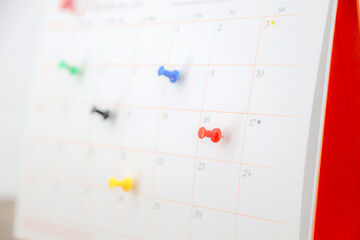 Desk calendar with pins for reminder in office workplace concept of time management agenda event...