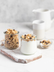 granola with chocolate, yogurt with granola in a glass jar