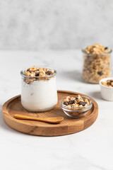 granola with chocolate, yogurt with granola in a glass jar