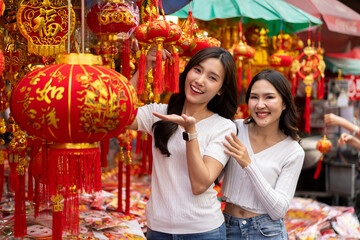 Young Asian Women Shopping for beautiful red ornament Offerings Outdoors market