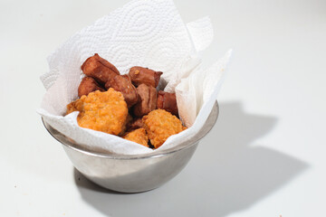 nuggets and sausages in bowl isolated on white background