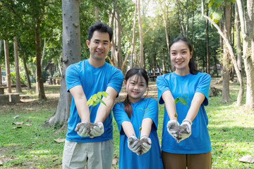 Family volunteers planting trees for a greener environment and saving the world