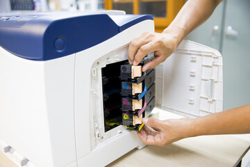 Technician Holding ink printer toner low for replace new or fix repair problem paper or print...
