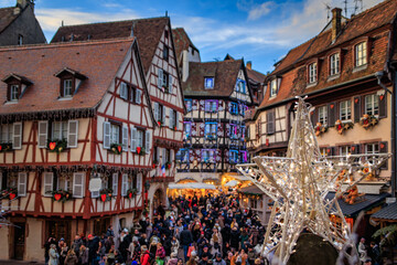 Crowds in Colmar, France, half timber houses decorated for Christmas Market
