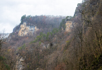 autumn walks along the canyon of the mountain river located in the gorge of the mountain range