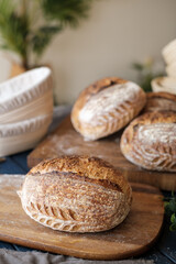 Artisan Batard Sourdough healthy Bread with leaf scoring. Open crumb high hydration Sourdough bread set on white table.