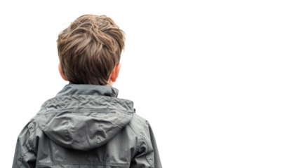 A boy with tousled hair, wearing a gray jacket, stands with his back to the viewer, contemplating his surroundings in a reflective moment.