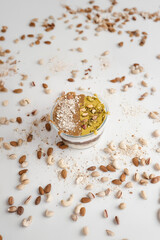 A delicious dessert in a jar topped with crushed almonds, pistachios, and cashews. A beautifully layered treat combining creamy textures and nutty flavors. Perfect for food photography and culinary pr