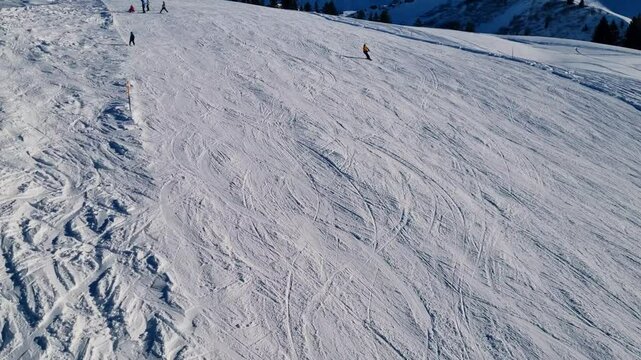 Shot of skiers and snowboarders descending the slopes in excellent snow conditions at B&uuml;hlberg in the Adelboden-Lenk ski area, Switzerland
