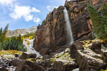 Majestic waterfall with autumn and snow