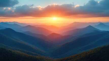 Obraz premium Vibrant sunset over a vast mountain range, showcasing layers of blue and orange hues.