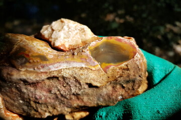 Flint nodule with a chip colored with iron oxides in yellow and red colors