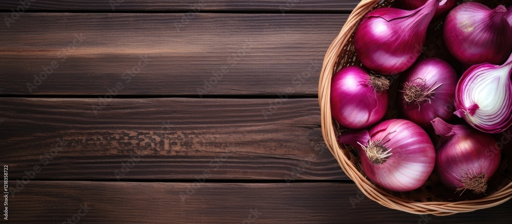 Poster Basket filled with whole and sliced red onions on a dark wooden background with ample copy space to the right for text or graphics.