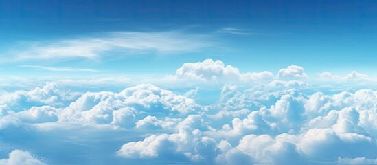 Serene blue sky background with fluffy white clouds floating above, ample space for text or elements, creating a tranquil and inviting atmosphere
