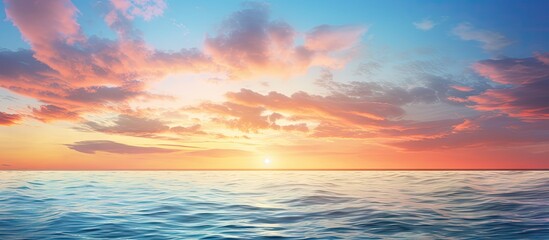 Fototapeta premium Vibrant sunset over a calm ocean with hues of orange blue and pink clouds reflecting on tranquil waters creating a serene seascape scene