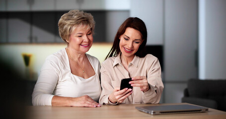 Fototapeta premium Teaching Tablet To Senior Woman