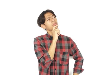 Young Asian man is thinking with eyes looking up, thinking, imagining,
