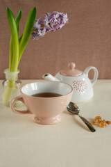 Teacup with a purple hyacinth.