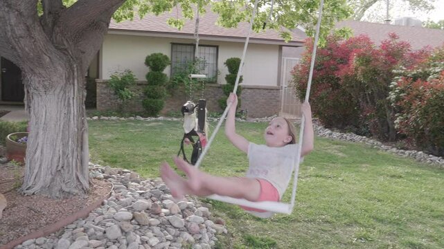 Little Girl Swinging from Tree Swing Closeup