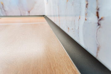 This image presents a closeup of a beautifully crafted wooden floor with intricate details,...