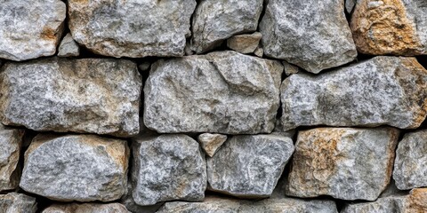 Close-up of gray stone wall texture featuring uneven surface patterns