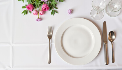 Elegant silverware arrangement on white cloth, refined dining concept