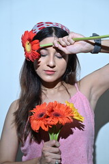 portrait of a girl with flowers. girl with gerbera flowers. smile and flowers. happy woman with flowers. greeting card, close eyes 