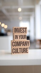 Wooden blocks with words 'Invest in your company culture'. Business concept
