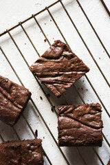 brownie pieces on a rack cooling down