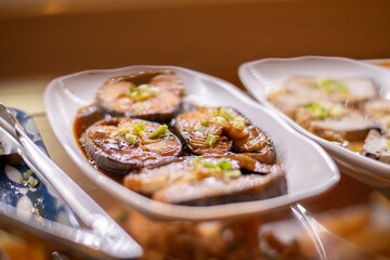 Teriyaki butterfish okazuya on display in Japanese deli case