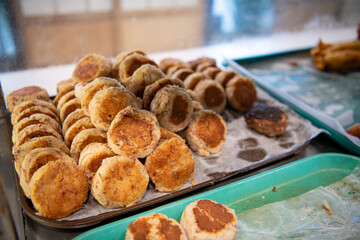 Okazuya potato hash patties on display in Japanese deli