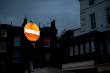 Lighted do not enter stop sign at dusk in London neighborhood