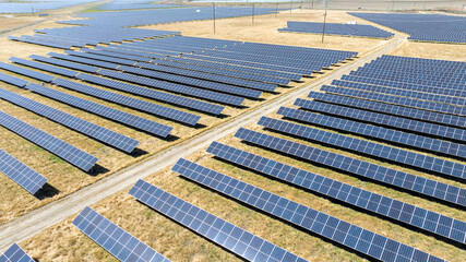 Aerial view of solar array farm on dry grass in Central California