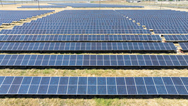 Aerial view of solar array farm on dry grass in Central California