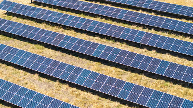 Aerial view of solar array farm on dry grass in Central California