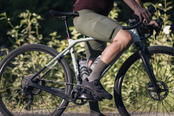 Close up of gravel bikers leg on pedal ready to ride