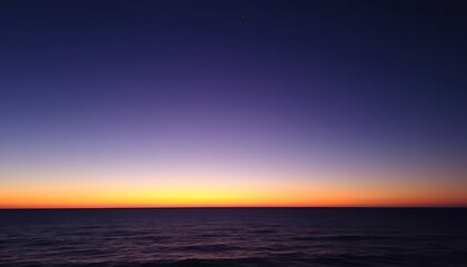 Obraz premium Serene Ocean Sunset: A Breathtaking View of the Twilight Hour