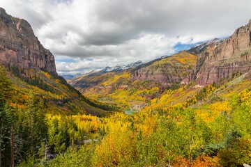 Scenic autumn valley with rocky mountains.