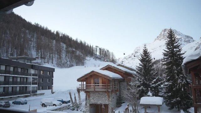 A shot of a ski resort mountain scene froma lodge balcony with a gondola in the background.
