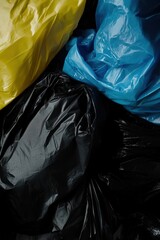 Plastic garbage bags in various colors stacked together, highlighting waste management practices and environmental responsibility in urban settings. Recycling and sustainability focus.
