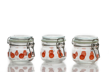Unique glass jars with bright patterns sit ready for storage and creativity in a minimalist setting