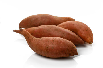 Sweet potatoes arranged artistically on a white surface for culinary inspiration and nutrition...